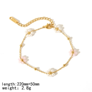 Detail of 18K gold stainless steel bracelet featuring pink and white bead flowers