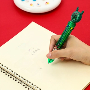 Stylo bille de Noël 10 couleurs avec design renne vert sur fond rouge festif