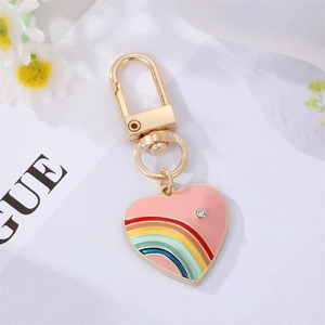 Pink heart keychain with rainbow enamel and crystal accent on gold metal ring