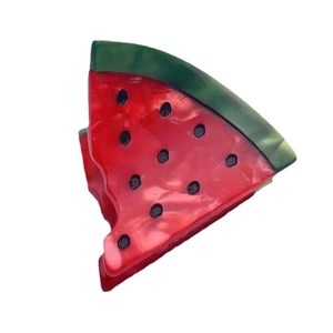 Creative watermelon slice hair clip in red and green acetate with Y2K style aesthetic