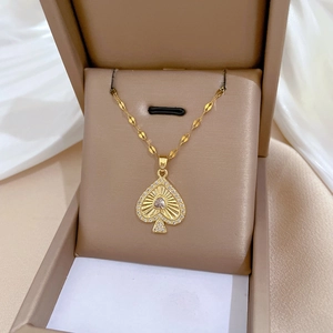 Macro view of gold heart pendant with crystal inlay in a premium leather gift box