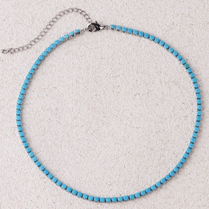 Detailed view of silver necklace with sky blue turquoise-style beads and lobster clasp