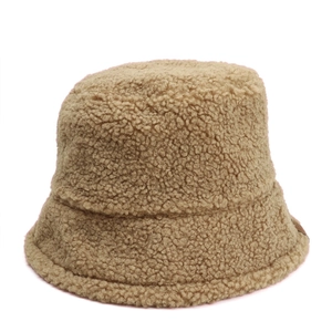 Detail of khaki faux shearling bucket hat with fluffy texture and leather side label