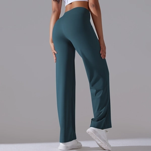 Close-up of high-waisted wide-leg yoga pants in dark green showing fit and stretch fabric