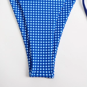 Detail of blue and white gingham knit texture on elastic bikini bottom fabric