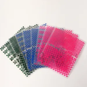 Detail view of multi-color checkerboard nail art stickers in navy, green and pink