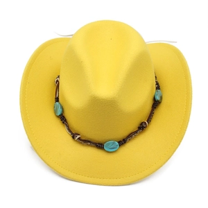 Detail of yellow wool cowboy hat featuring turquoise bead accents and woven leather band