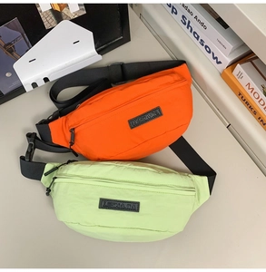Detail of orange and light green nylon cross-body bags with adjustable shoulder straps