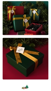 Close-up of festive red and green gift boxes with golden ribbons and pine branches