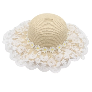 Cute girl's beige straw sun hat with white lace trim and delicate daisy floral decorations