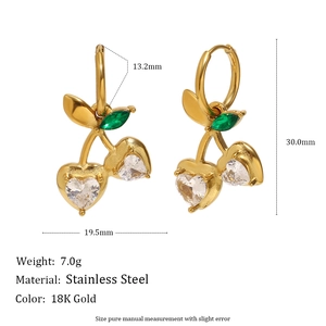 Detail view of 18K gold cherry earrings with dimension specs and heart-shaped gems