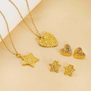 Detail shot of golden heart and star jewelry set with unique textured metal finish