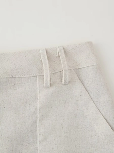 Detailed close-up of linen skirt waist with double belt loops and side pocket stitching