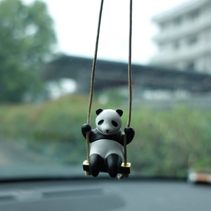 Close-up of a 3D panda swinging ornament for car rearview mirror or desk decoration