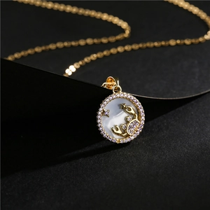 Gold plated zodiac necklace with purple zircon stones and mother of pearl inlay