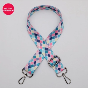Close-up of a 38mm wide colorful patterned bag strap with gunmetal hardware