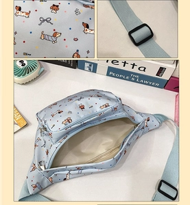 Close-up of light blue cartoon dog print waist bag with plastic buckle and zipper detail