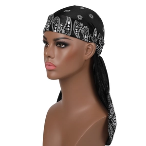 Close-up of black satin durag with white paisley patterns on professional mannequin head