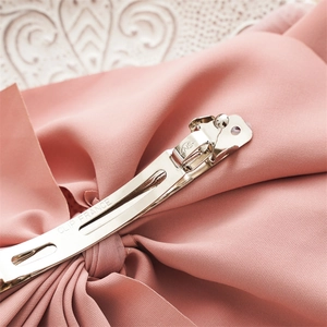 Pink fabric bow hair clip with high-quality metal spring fastener and engraved details