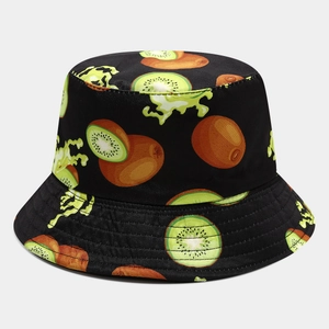 Detail of reversible bucket hat featuring vibrant kiwi fruit patterns on black twill cotton