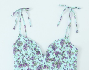 Detail of light blue floral print poplin top with adjustable shoulder tie straps