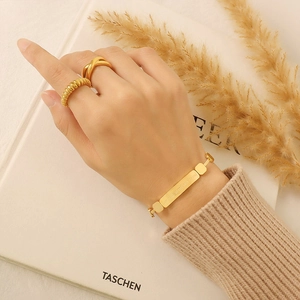 Elegant 18K gold plated stainless steel bracelet and rings set with engraved minimalist charms