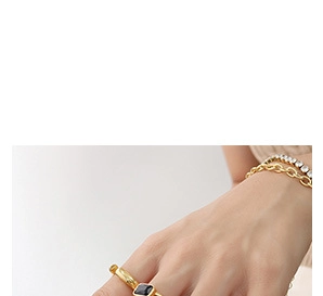 Detailed shot of 18K gold ring featuring a square black gemstone inlay for women
