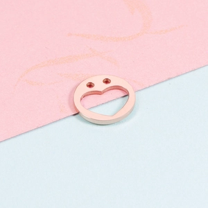 Polished 12mm rose gold stainless steel heart cutout pendant shown on a pastel background