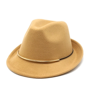 Macro detail of the camel fedora hat featuring a black band and golden metal buckle