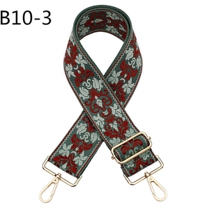 Close-up of vintage floral jacquard bag strap with gold lobster clasps and buckles