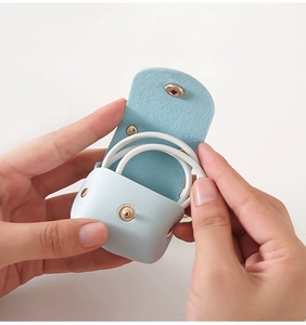 Close-up of light blue PU leather mini storage pouch with gold snap button for AirPods