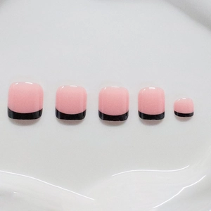 Pink and black French tip press-on toenails with glossy finish on white background