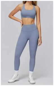 Detailed fit of high-waist yoga pants and racerback sports bra set in blue grey