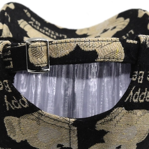 Close-up of adjustable silver metal buckle and bear jacquard fabric on baseball cap