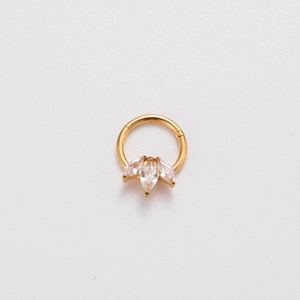 Detail of 16G gold stainless steel nose ring with three teardrop white zircons on white base