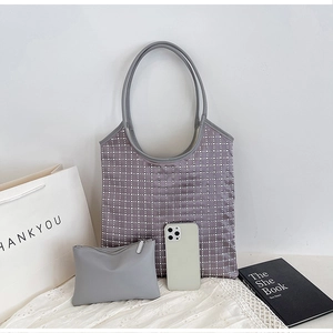 Detail view of large tote bag with sparkling rhinestones and matching inner pouch for women