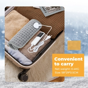 Portable gray flannel heating pad for neck and back shown packed in a suitcase