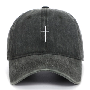 Detail of high-quality white cross embroidery on a dark grey washed cotton baseball cap