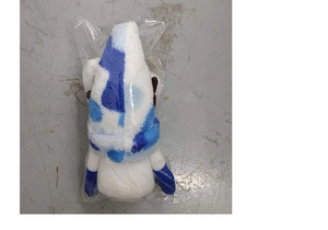 Close-up of a white plush Christmas gnome with blue patterned hat in clear packaging