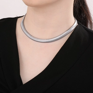 Close-up of 8mm silver flat snake chain necklace in titanium steel on a model neck