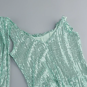 Close-up of mint green sequins and pleated mesh fabric on elegant evening dress