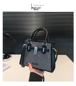 Close-up of sparkling silver rhinestones on the luxury black crossbody bag with metal lock