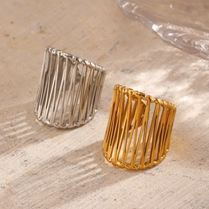 18K gold and silver chunky hollow line rings set on a light wood surface