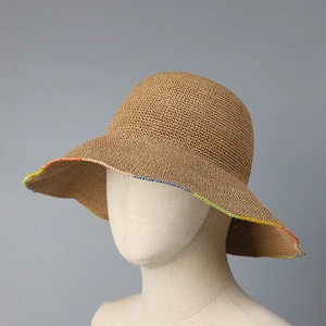 Deep khaki handwoven straw sun hat with colorful crochet edges on a display model