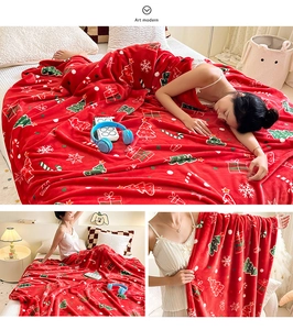 Detail of red Christmas flannel blanket featuring snowflake and festive gift patterns