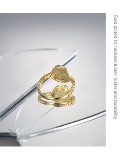 Detailed view of the gold plated ring's texture and luster on a reflective mirror base