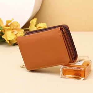 Detailed side view of brown leather tri-fold wallet showing zipper and compact layers