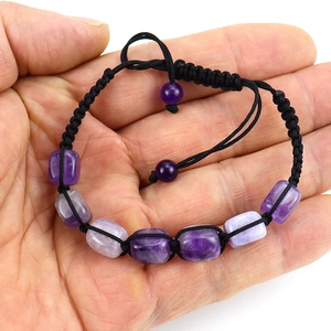 Macro shot of hand-woven amethyst beaded bracelet with adjustable black nylon cord closure