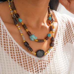 Close-up of bohemian double-layer necklace with turquoise stones and acrylic beads