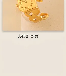 Macro shot of gold Roman numeral watch-style ring with chunky chain band detail